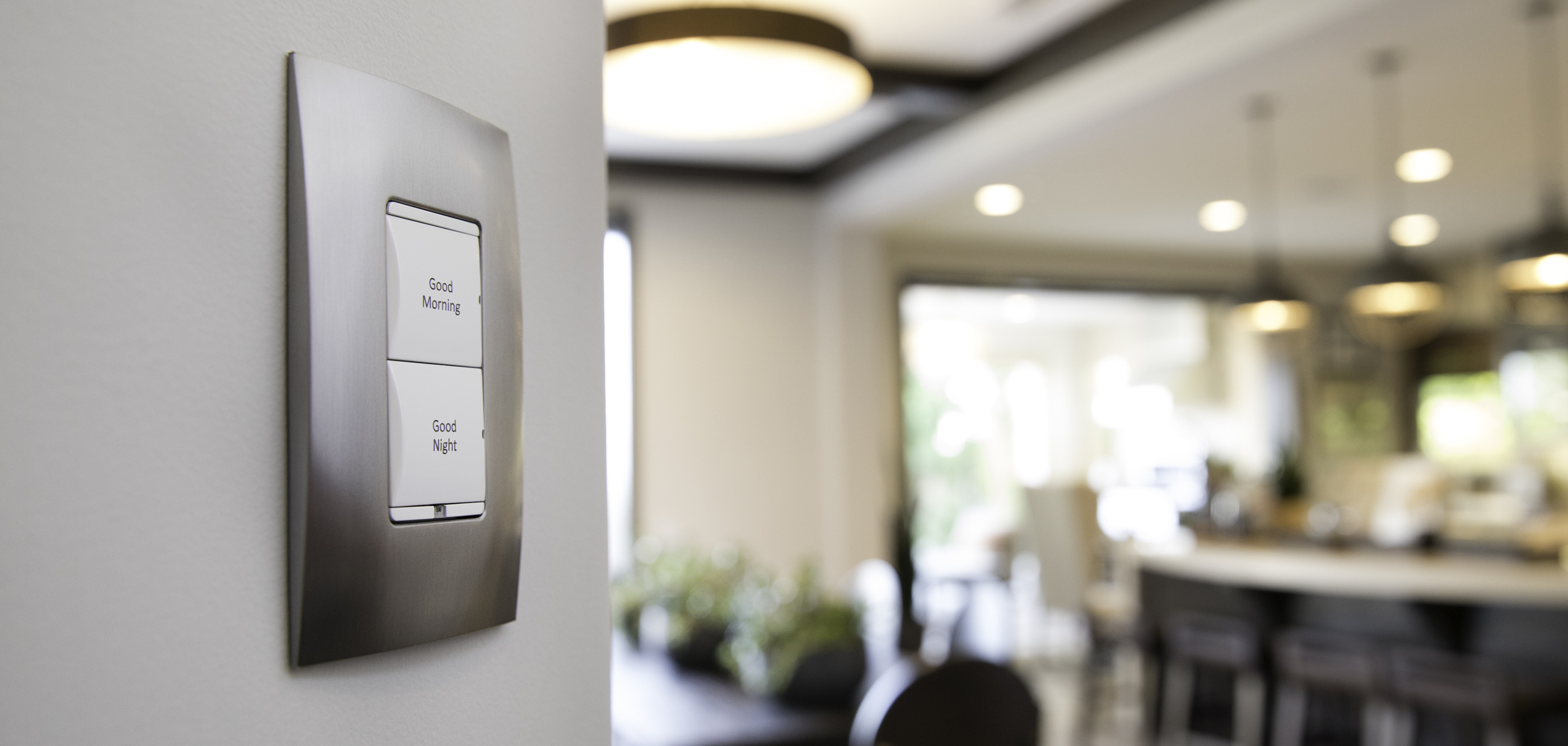Control4 Touch panel in a able with a traditional home in the background