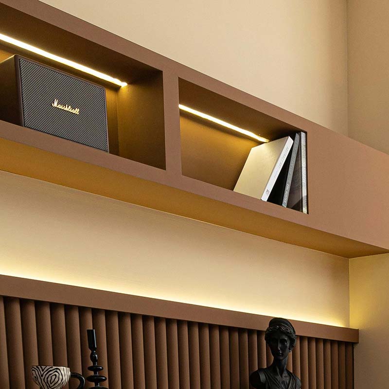 Wooden shelves with built-in LED illumination, adding a subtle glow around displayed items.