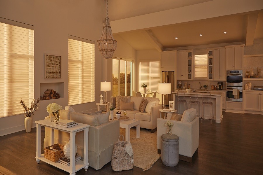 A sophisticated great room bathed in warm wood floors, neutral colors, and Lutron lighting.