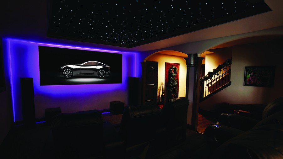 Darkened Home cinema installation with projector and tower speakers. 